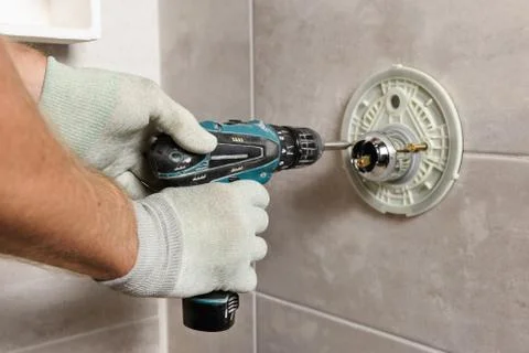 Installing the built-in faucet. Stock Photos