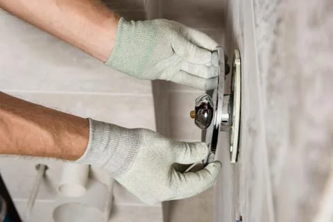 Installing the built-in faucet. Stock Photos