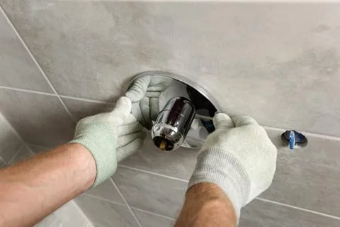 Installing the built-in faucet. Stock Photos