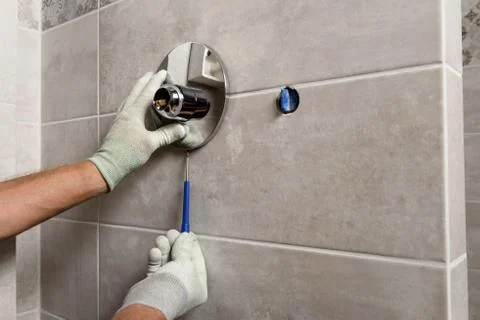 Installing the built-in faucet. Stock Photos