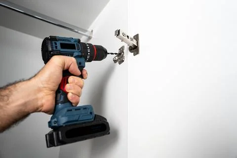 Installing Cabinet Hinge With Cordless Drill Stock Photos