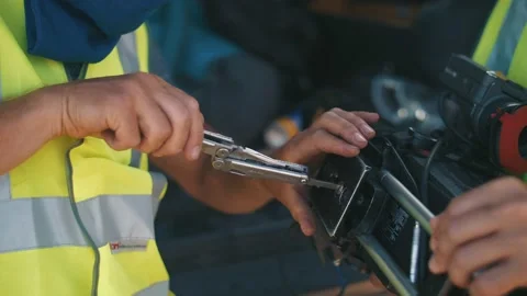 Installing a camera on a crane. A man sets up a platform on a movie camera Stock Footage 197376360