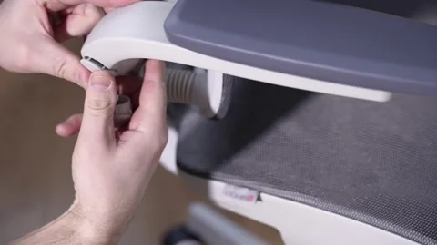 Installing the caps in the chair armrests. The final stage of furniture assembly Stock Footage 327910185