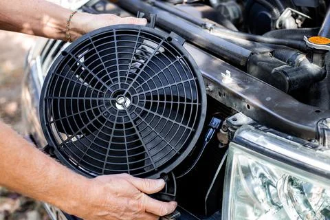 Installing a car engine cooling fan. Auto repair and maintenance. Fotos Stock