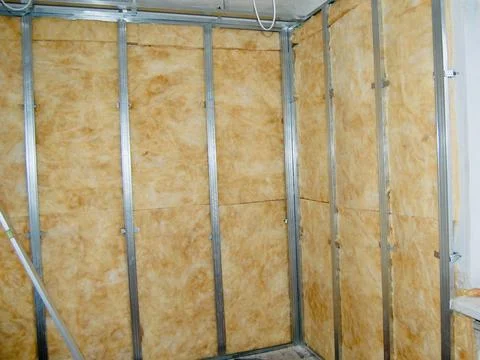 Installing ceiling metal frame with U-shaped brackets and mineral wool insu.. Stock Photos