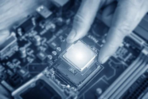 Installing central processor unit into computer motherboard. Stock Photos