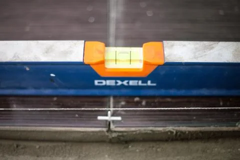 Installing ceramic floor tiles - measuring and cutting the pieces, closeup Stock Photos