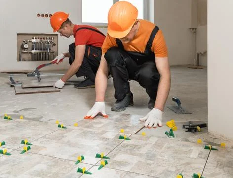 Installing ceramic tiles on the floor. Stock Photos