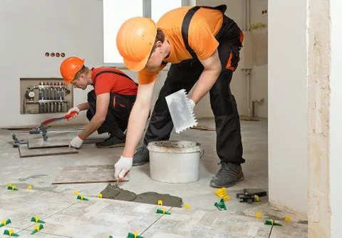 Installing ceramic tiles on the floor. Stock Photos