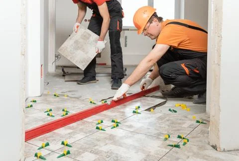 Installing ceramic tiles on the floor. Stock Photos