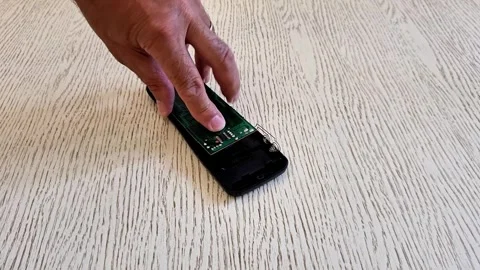 Installing Circuit Board into TV Remote Control Housing by Hand Stock Footage 340746814