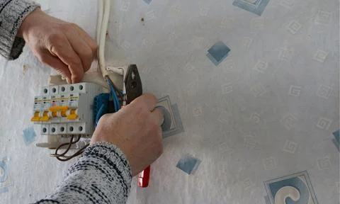 Installing circuit breakers in a plastic electrical distribution board 스톡 사진