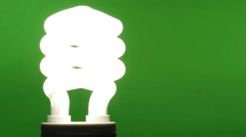 Installing a Compact Fluorescent Bulb on Green Stock Footage 68640397