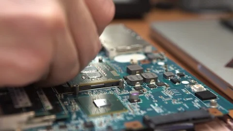 Installing Computer Processor. Man Repair Laptop Motherboard With Screwdriver Stock Footage 120016071