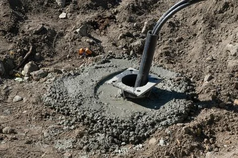 Installing Concrete Base with Pipe at Construction Stock Photos