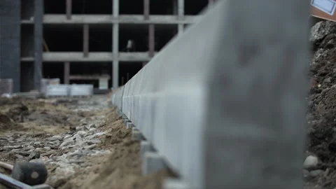 Installing concrete curb along construction site base Stock Footage 326064431