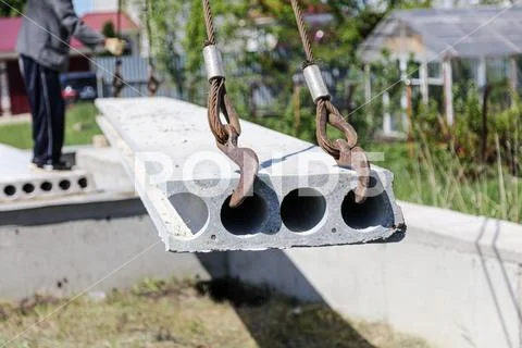 Installing concrete slabs at a construction site at home Stock Photos