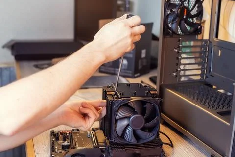 Installing a cooler on a personal computer processor. Stock Photos