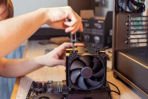 Installing a cooler on a personal computer processor. Stock Photos