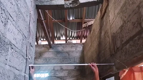 Installing Curtain Rod Bracket on Home Wall Stock Footage 321785942