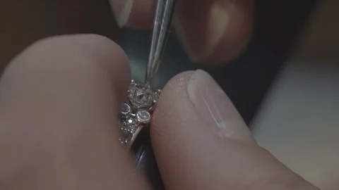 Installing diamond into ring crown jewelry Stock Footage 82189454