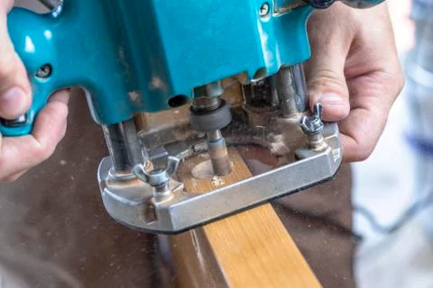 Installing a door, Install a door lock, use a milling saw, a carpenter close- Stock Photos