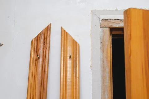 Installing the door trim inside the room. Wooden door and two decorative casi Stock Photos