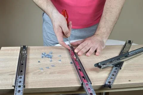 Installing a Drawer Slides on a Cabinet Stock Photos