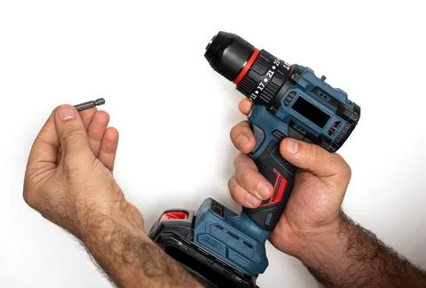 Installing drill bit into cordless drill Stock Photos