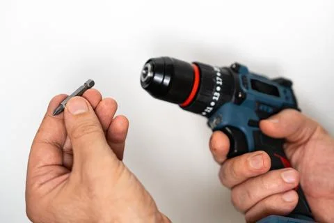 Installing drill bit into cordless screwdriver close up Stock Photos