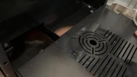 Installing drip tray into automatic coffee machine. Close up of placing Stock Footage 336976964