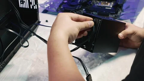 Installing the drive cage with hard drive and SSD into the computer case Stock Footage 328987211