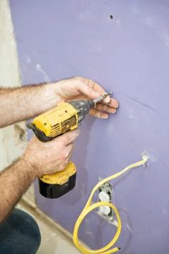 Installing Drywall Screws Stock Photos