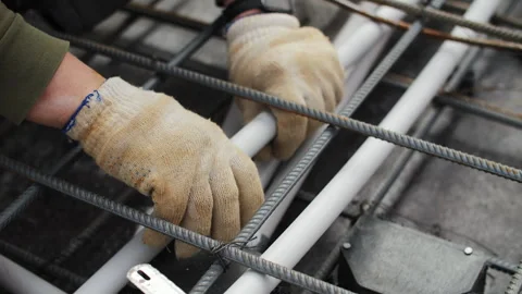 Installing electrical conduit pipes in rebar grid Stock Footage 306459997