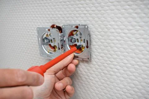 Installing an electrical outlet in the socket box Stock Photos