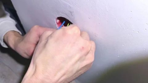 Installing an electrical outlet in a wall with careful attention to wiring and s Stock Footage 326377531