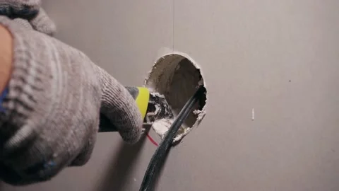 Installing an electrical outlet in the wall Stock Footage 198517134