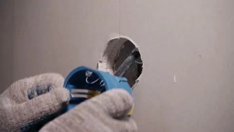 Installing an electrical outlet in the wall Stock Footage 199044740
