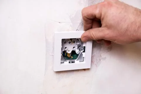 Installing an electrical outlet . The wall indicates that renovation work i.. Stock Photos