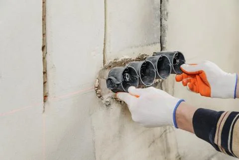 Installing electrical socket box. Stock Photos