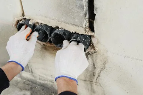 Installing electrical socket box. Stock Photos