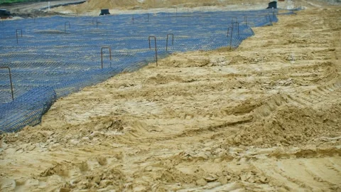 Installing erosion control matting on sandy soil Stock Footage 310521559