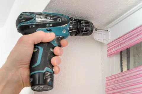 Installing fabric roller blinds. Stock Photos