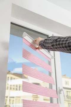 Installing fabric roller blinds. Stock Photos