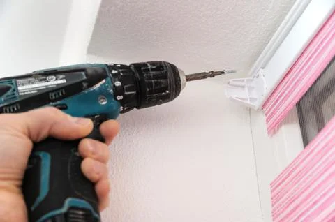 Installing fabric roller blinds. Stock Photos