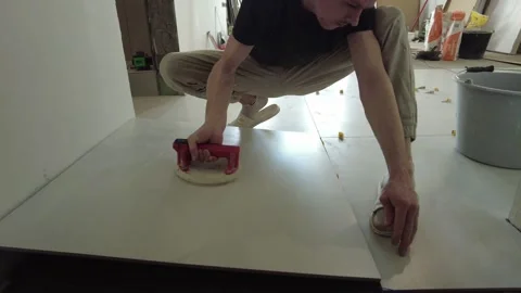Installing floor panels in a construction site using a suction tool in the after Stock-Footage 332455277