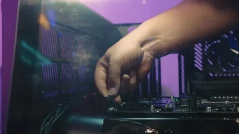 Installing front panel cables onto motherboard pins during computer assembly Stock Footage 328985966