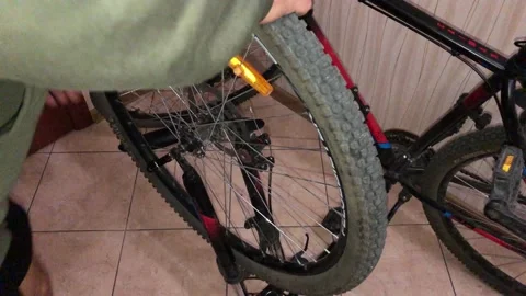 Installing the front wheel on a Bicycle Stock Footage 142697760