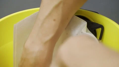 Installing a garbage bag in a vacuum cleaner. A man changes a garbage bag  Video stock 290801122