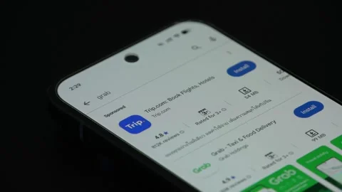 Installing Grab application on mobile phone screen close up Stock Footage 340053233